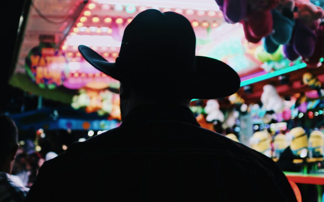Cloverdale Rodeo - Silhouette of a man in a cowboy hat at the fair - blake-guidry-NEdktBIUg4I