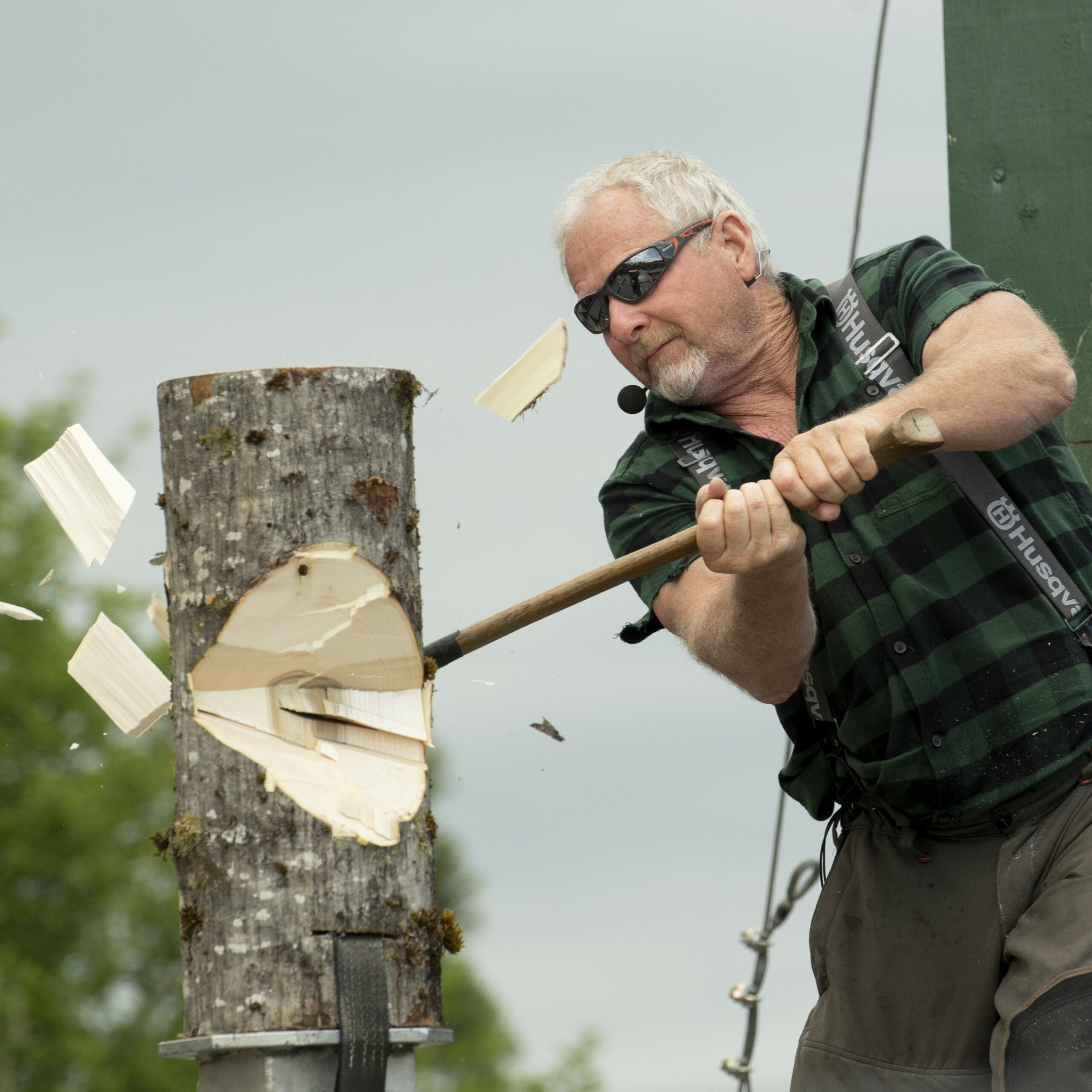 Lumberjack chopping with na axe - at the Cloverdale Rodeo & Country Fair