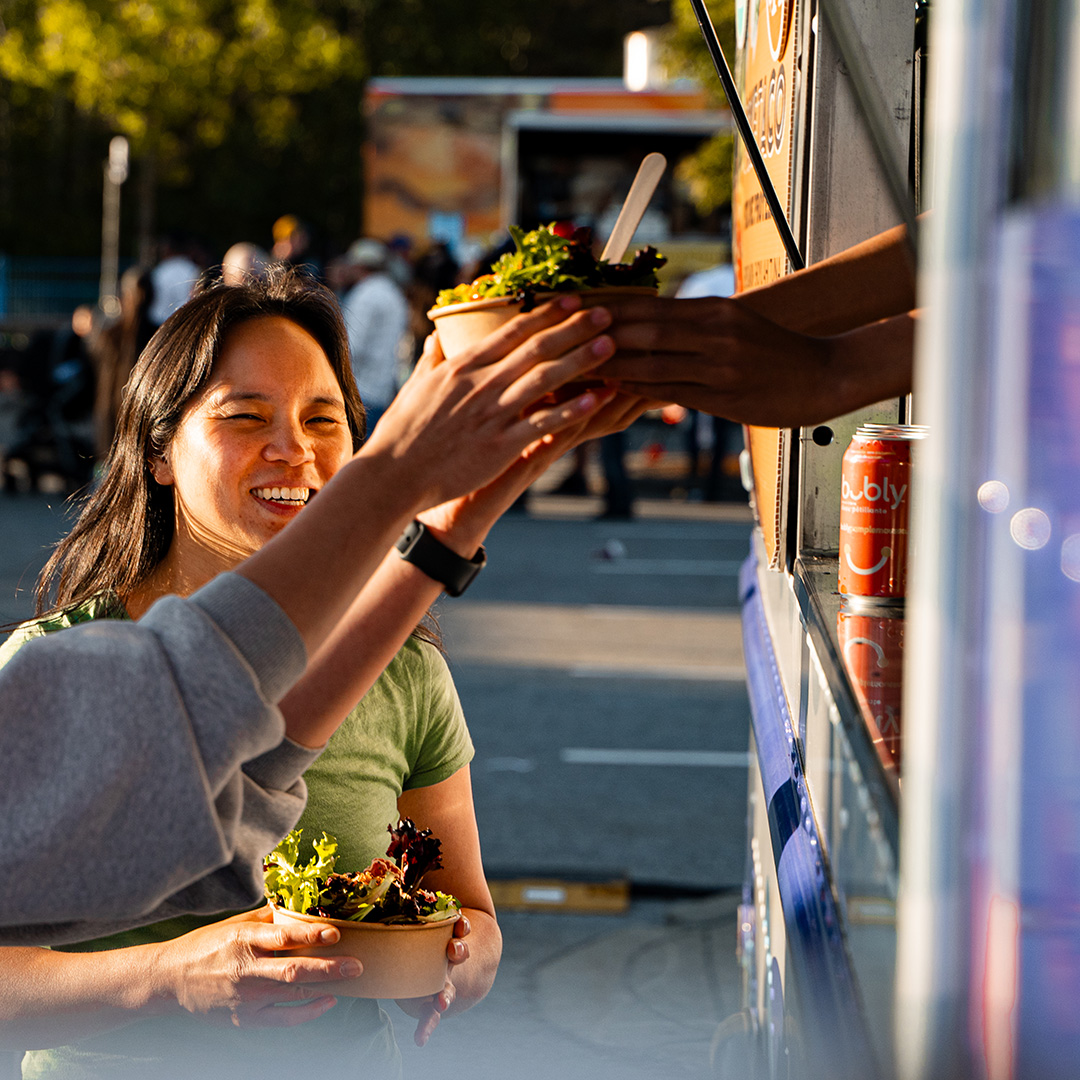 A fairgoer is handed a bowl of poke from a food truck a the Cloverdale Rodeo & Country Fair