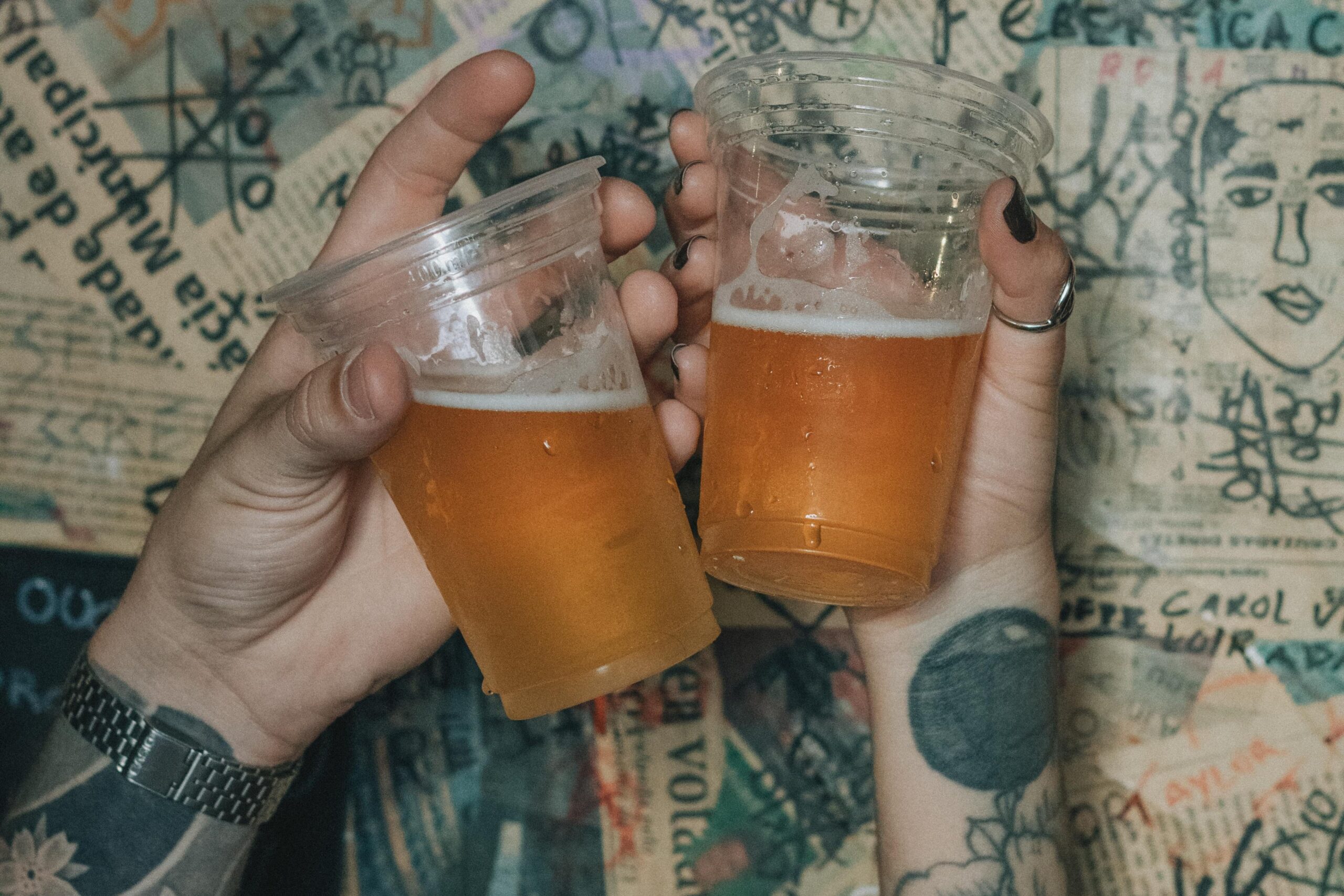 Beer in plastic cups with blurred lights behind